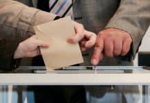 hands-voting-ballot-box