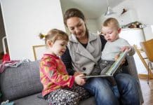 mother-children-book-read-couch-apartment-baby