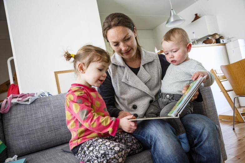 mother-children-book-read-couch-apartment-baby