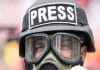 journalist with gas mask