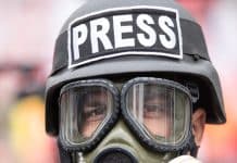 journalist with gas mask