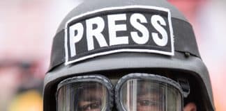 journalist with gas mask