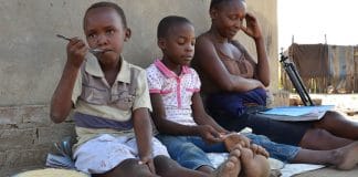 A mother homeschools her children in Shamva district, Zimbabwe, during the COVID-19 pandemic.