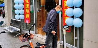 A resident weighing himself on a scale outside a drug store. in Wuhan, China, on April 8, when the lockdown of the city was ended after 76 days. Scales outside drug stores are pretty common in China.