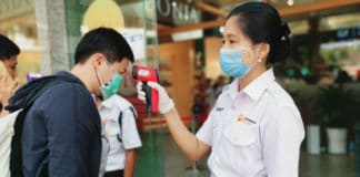 Staff check customers’ temperatures at a shopping mall entrance in Yangon, Myanmar.