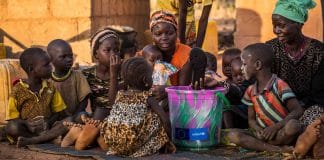 A mother holds her 3-month-old baby as he receives a vaccination against measles at a health centre in Lubumbashi, Democratic Republic of the Congo.