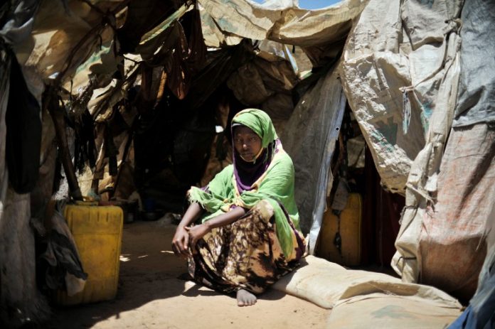 A woman sits outside her home in Mogadishu, Somalia. UN Photo/Tobin Jones.