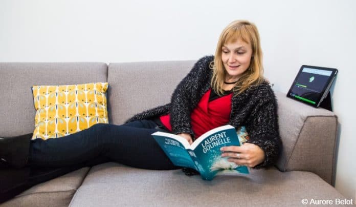 Person on couch reading to blind and visually impaired