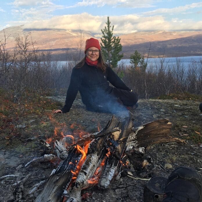 Elin Marakatt is Sami sitting in front of a fire