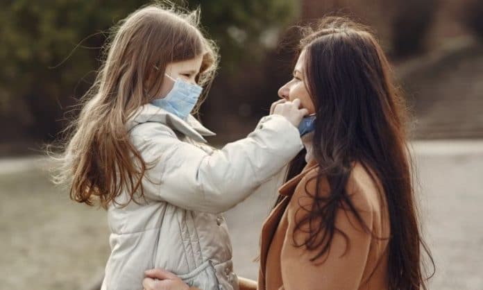 mother and daughter wearing masks