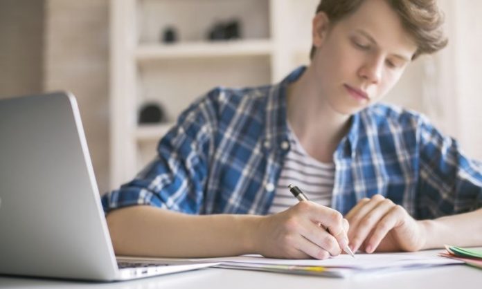 boy writing an essay