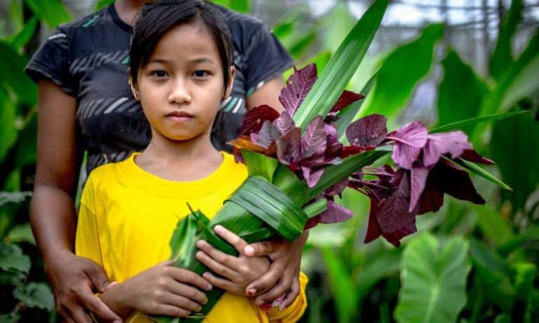 Indigenous person holding flowers