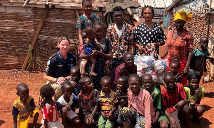 The first footballs are handed out to Asma, Community Watchgroup leader in Naivasha IDP-camp