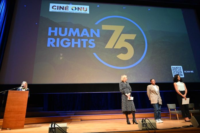 Shadille Estapan, Anicet, and Alexandra Daisy Ginsberg read their chosen article  on stage.