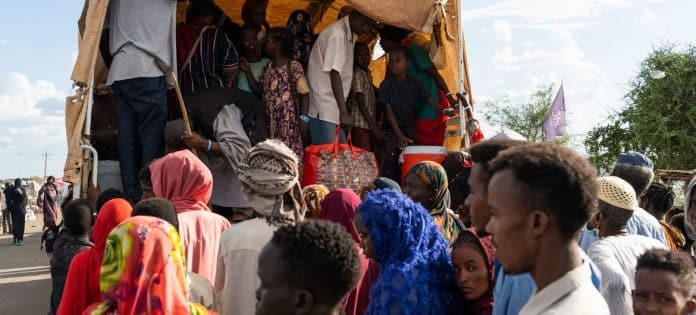 A group of people entering a camp in Sudan