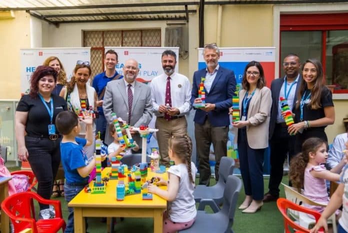 A group of people with colorful bricks