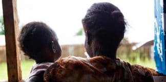 A victim of domestic violence with her child in South-Sudan.