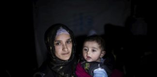 Hakima, 21, holds her four-month-old baby, Jad, at Bar Elias refugee settlement in Lebanon