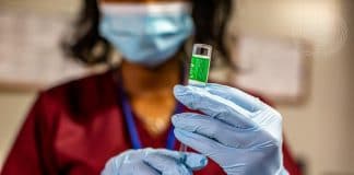 a doctor administering a vaccine on a patient