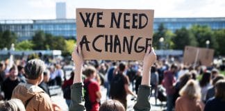 Rear,View,Of,People,With,Placards,And,Posters,On,Global climate change