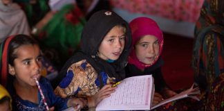 Young girls study at a child-friendly space for internally displaced children, where activities combine education and play.