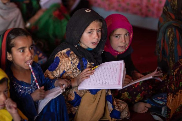 Young girls study at a child-friendly space for internally displaced children, where activities combine education and play.