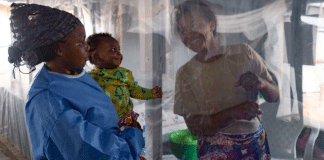 A plastic sheet separates a mother from her son at an Ebola treatment centre in North Kivu province, eastern DRC.