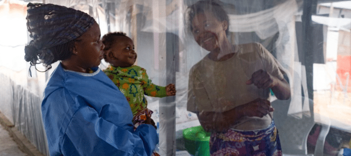 A plastic sheet separates a mother from her son at an Ebola treatment centre in North Kivu province, eastern DRC.