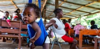 A child is weighed before receiving multiple vaccines at an outreach clinic near Camp-Perrin, Haiti.