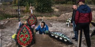 A mother in Bucha, Ukraine, buries her son