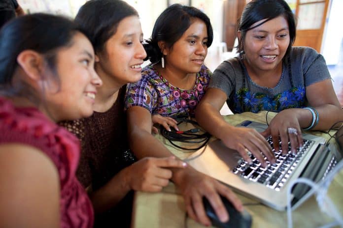 In this picture, women are using a computer