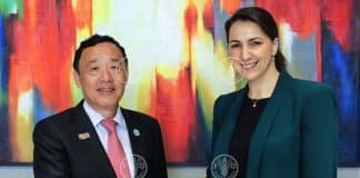 FAO Director-General QU Dongyu meeting with Mariam Al Mheiri, Minister for Climate Change and Environment of the United Arab Emirates (UAE) alongside the G20 Agriculture Ministers Meeting shaking hands