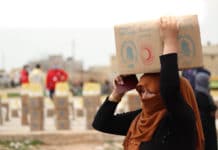 A-woman-collects-food-in-Deir-Hafer-60-km-from-Aleppo-Syria-Photo-WFP-Khudr-Alissa