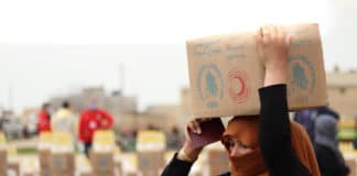 A-woman-collects-food-in-Deir-Hafer-60-km-from-Aleppo-Syria-Photo-WFP-Khudr-Alissa