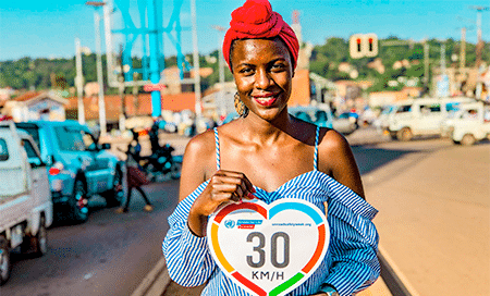 Woman holding speed limit sign