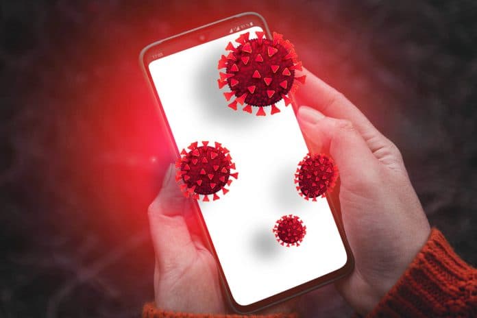 Person hands holding smartphone with dirty infectious bacteria and harmful germs on mobile smartphone display. Online hacker attack on confidential information or personal data.